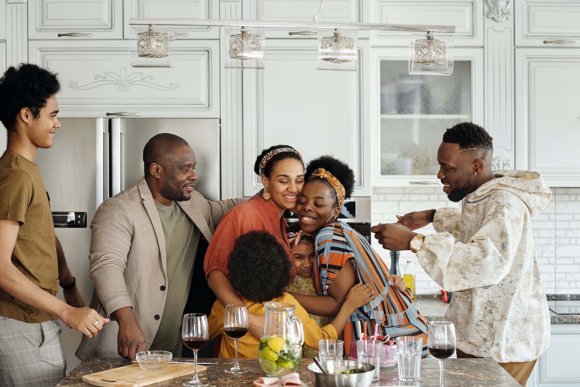 picture of family smiling and talking in kitchen