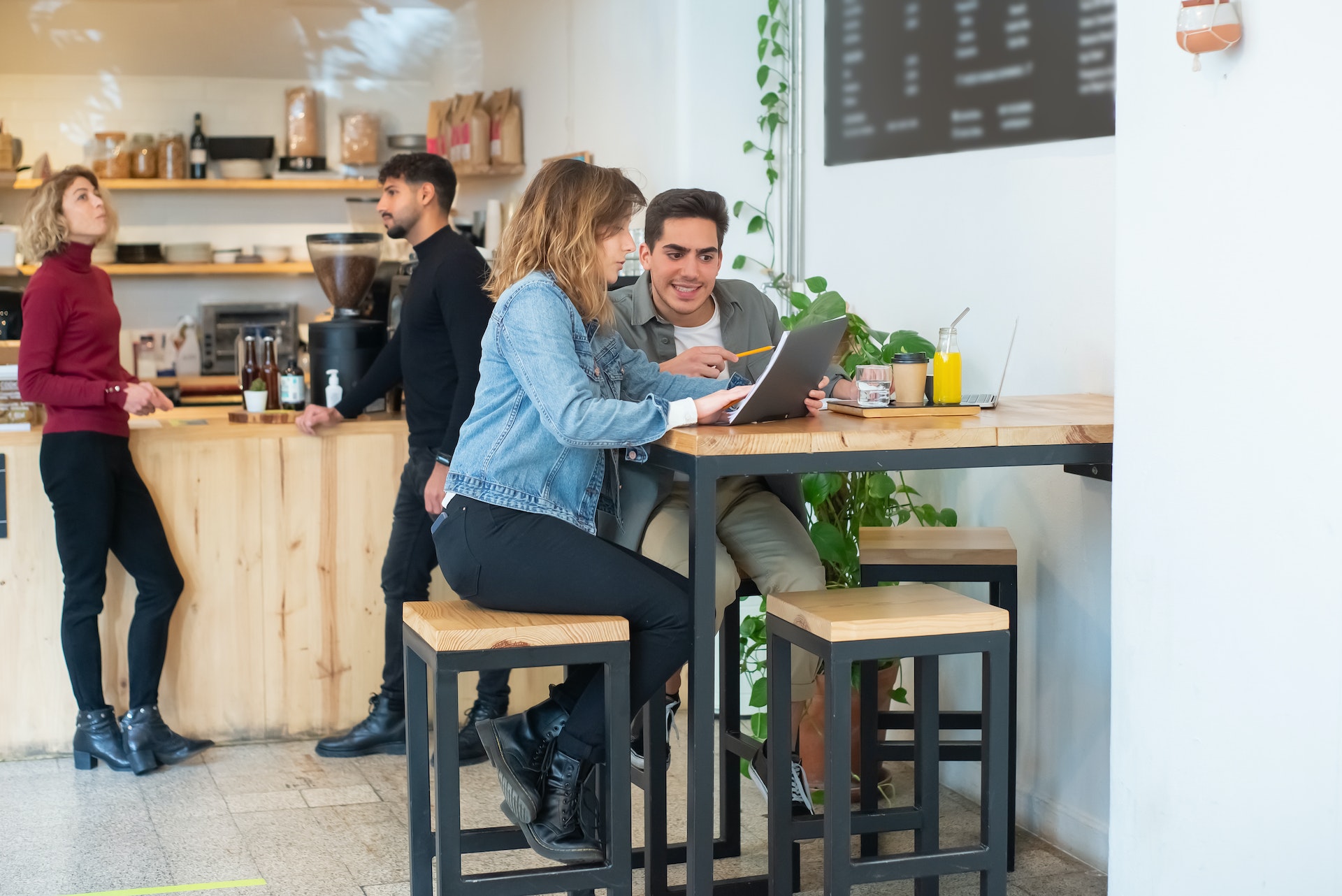 image of two parents talking with laptop in a small cafe setting