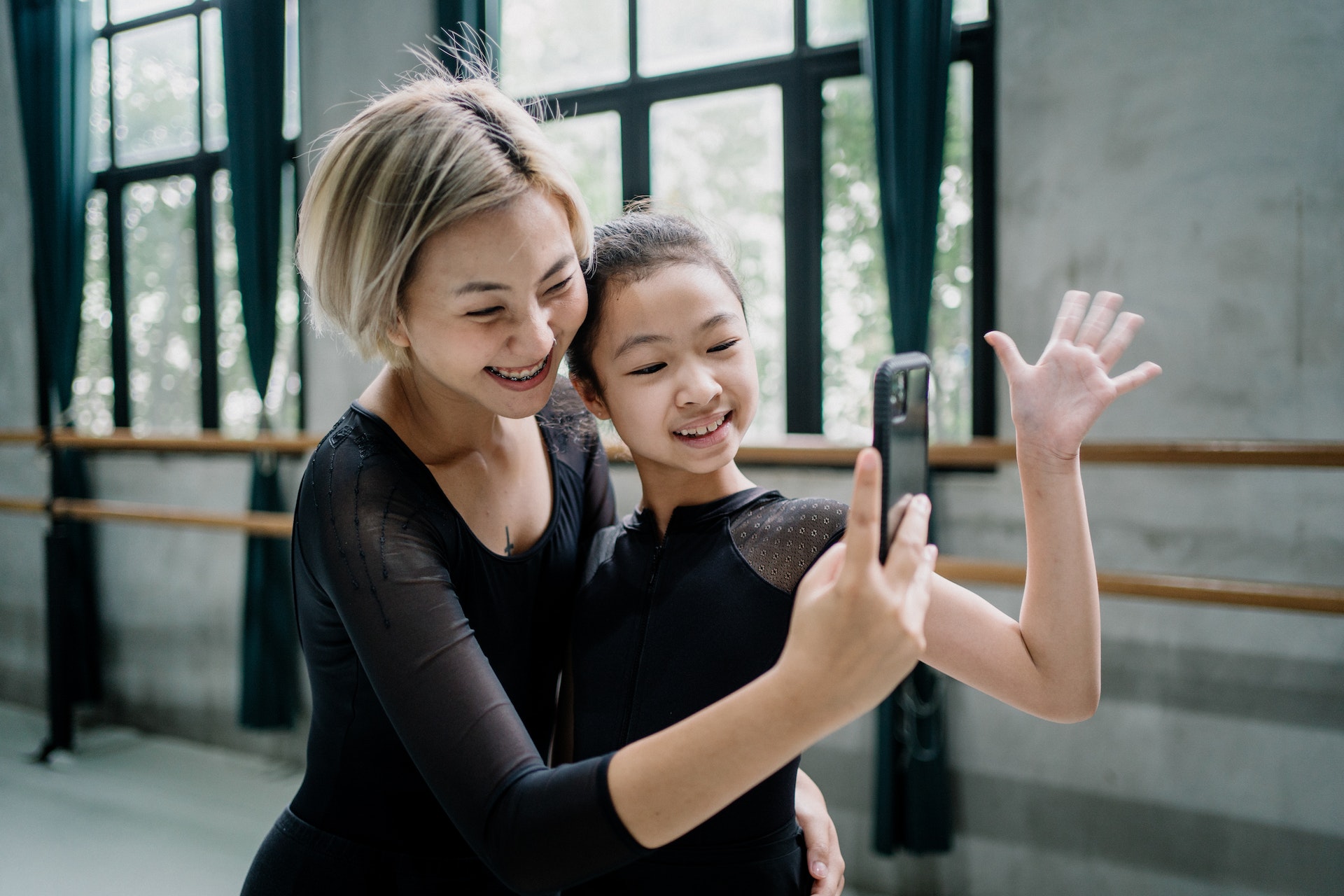 Mother and daughter at dance smiling for selfie photo