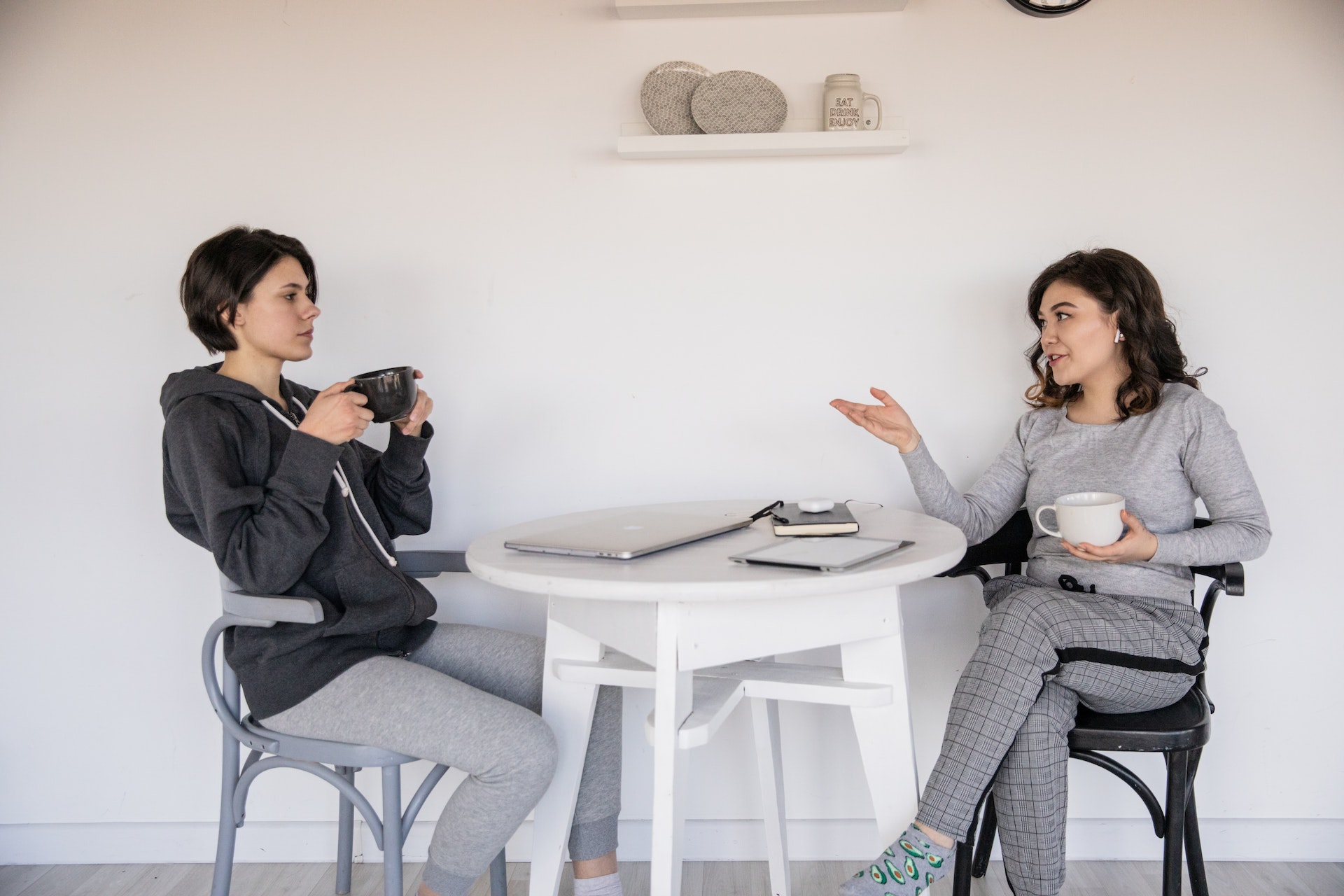 Two women sitting at a table talking 