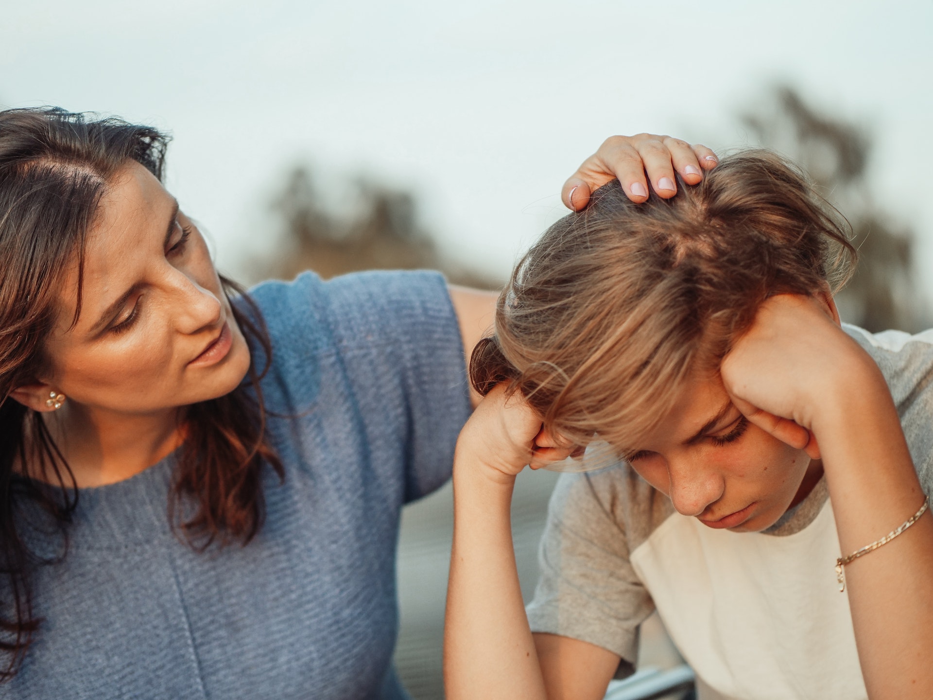 mother comforting daughter